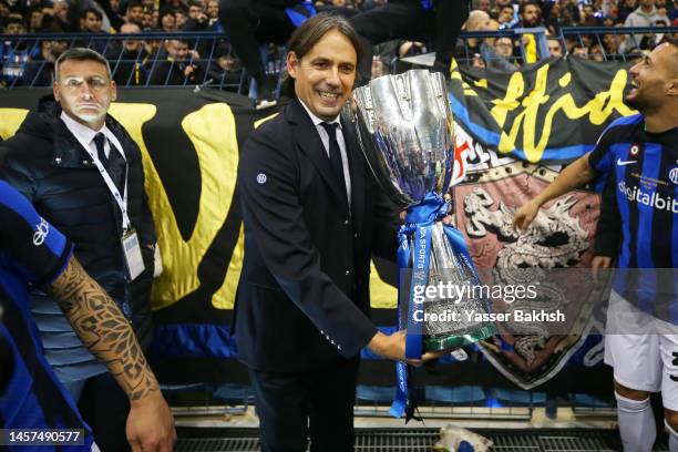 Simone Inzaghi, Head Coach of FC Internazionale, celebrates with the EA Sports Supercup after the team's victory during the EA Sports Supercup match...