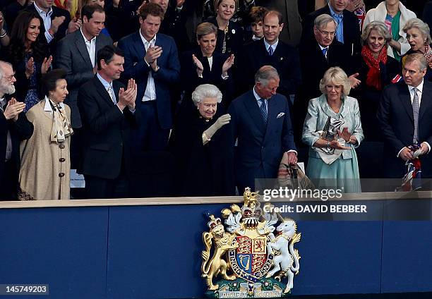 Britain's Queen Elizabeth II waves from the Royal Box surrounded by guests including members of the royal family and the clergy Archbishop of...