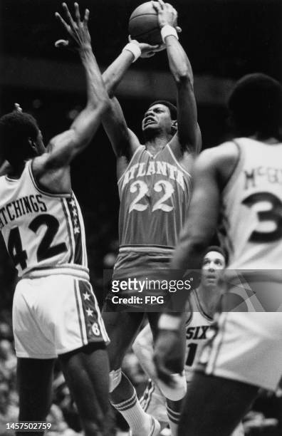 John Drew of the Atlanta Hawks goes for the basket against players from the Philadelphia 76ers in an NBA basketball game, The Spectrum Arena,...