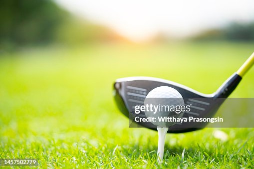 Teeing off with golf club and golf ball