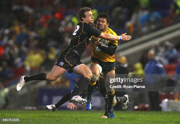 Digby Ioane of Australia is tackled by Matthew Scott of Scotland during the International Test match between the Australian Wallabies and Scotland at...