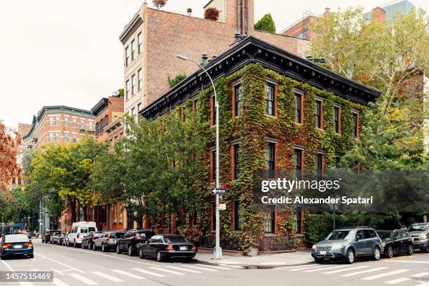 green building facade covered with ivy in greenwich village, new york, usa - new york city wall stock pictures, royalty-free photos & images