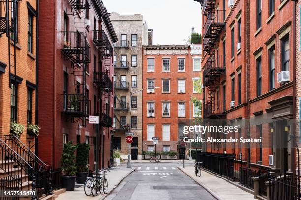 street with residential apartment buildings in west village, new york city, usa - greenwich village photos et images de collection