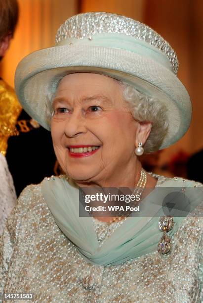 Queen Elizabeth II smiles as she talks to guests in the Egyptian room of Mansion House, for a reception hosted by the Lord Mayor of London and the...