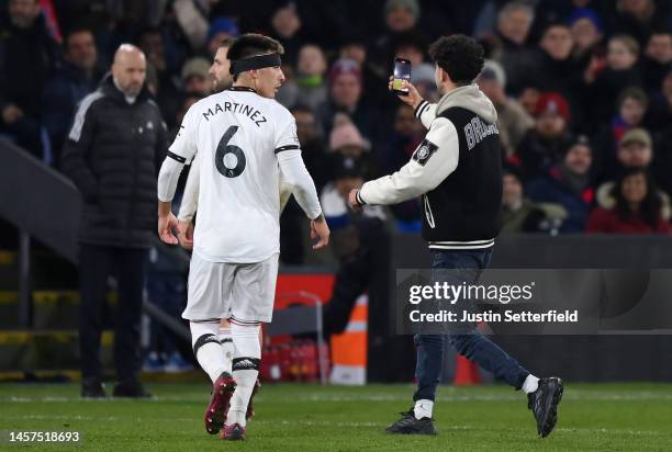 Pitch invader takes a selfi during the Premier League match between Crystal Palace and Manchester United at Selhurst Park on January 18, 2023 in...