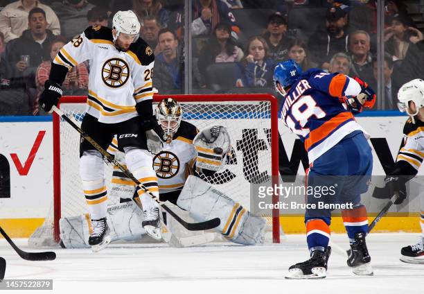 Linus Ullmark of the Boston Bruins catches a first period shot by Anthony Beauvillier of the New York Islanders at UBS Arena on January 18, 2023 in...