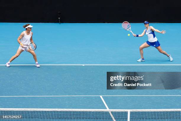 Alize Cornet of France plays a forehand in their round one doubles match against Hao-Ching Chan of Chinese Taipei and Zhaoxuan Yang of China during...