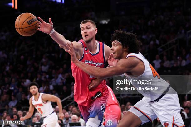 Kristaps Porzingis of the Washington Wizards and Jericho Sims of the New York Knicks go for a loose ball during the second quarter of the game at...