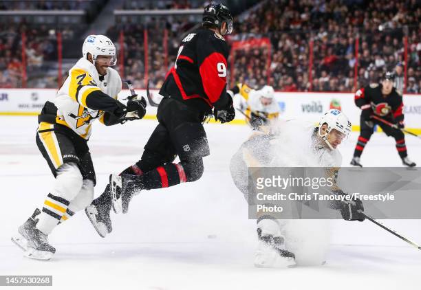 Josh Norris of the Ottawa Senators avoids a bodycheck by Teddy Blueger of the Pittsburgh Penguins and Pierre-Olivier Joseph during the second period...