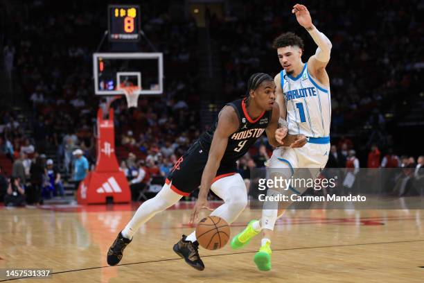 Josh Christopher of the Houston Rockets drives around LaMelo Ball of the Charlotte Hornets during the first half at Toyota Center on January 18, 2023...