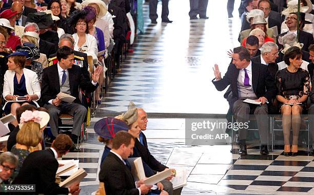 Britain's Prime Minister David Cameron, acknowledges the Leader of the Opposition Labour Party, Ed Miliband, as they attend a National Service of...