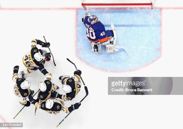 The Boston Bruins celebrate a second period goal by Derek Forbort against Semyon Varlamov of the New York Islanders at UBS Arena on January 18, 2023...