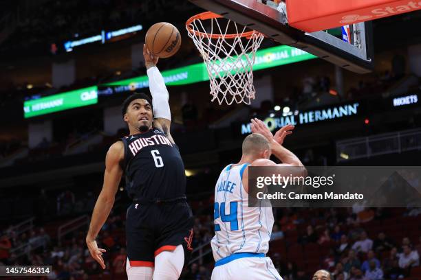 Kenyon Martin Jr. #6 of the Houston Rockets attempts a dunk over Mason Plumlee of the Charlotte Hornets during the first half at Toyota Center on...