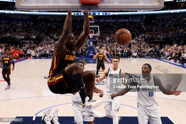 Clint Capela of the Atlanta Hawks dunks the ball against Dorian Finney-Smith of the Dallas Mavericks in the fourth quarter at American Airlines...