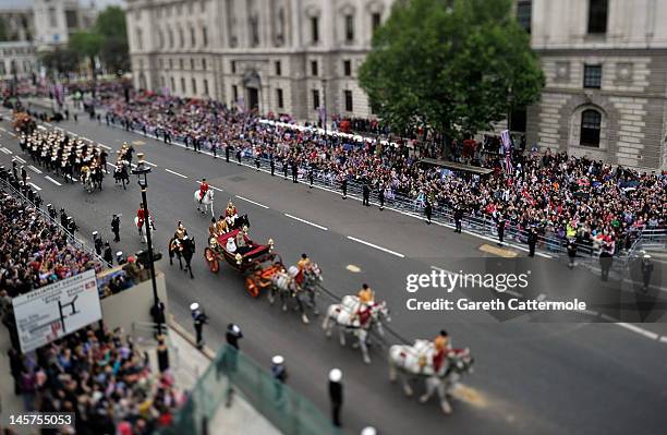 Queen Elizabeth II, Prince Charles, Prince of Wales and Camilla, Duchess of Cornwall ride in a carriage towards Buckingham Palace as part of the...