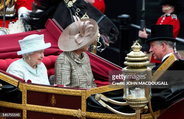 Britain's Queen Elizabeth II , Camilla, Duchess of Cornwall and Prince Charles, Prince of Wales ride in the 1902 State Landau coach during the...