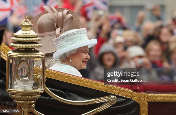 Queen Elizabeth II rides towards Buckingham Palace in a royal procession during the Diamond Jubilee on June 5, 2012 in London, England. For only the...