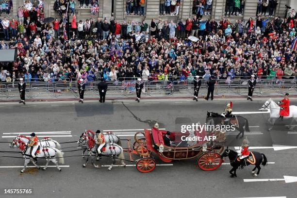 Queen Elizabeth II travels by carriage to Buckingham Palace with Camilla, Duchess of Cornwall and Prince Charles, Prince of Wales during the carriage...