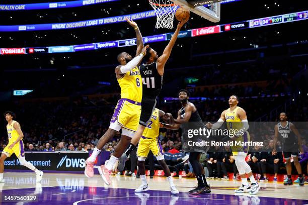 Trey Lyles of the Sacramento Kings takes a shot against LeBron James of the Los Angeles Lakers in the first half at Crypto.com Arena on January 18,...