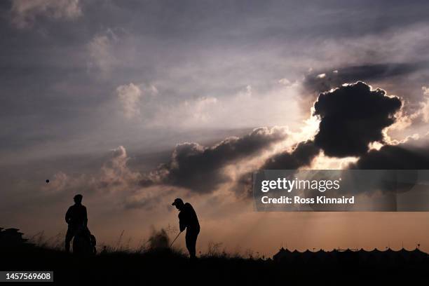 Silhouette as Mikko Korhonen of Finland plays his third shot on the second hole during day one of the Abu Dhabi HSBC Championship at Yas Links Golf...