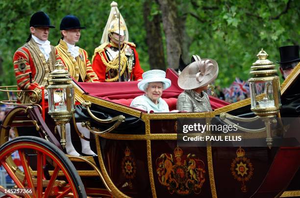 Britain's Queen Elizabeth II and Camilla, Duchess of Cornwall, ride in the 1902 State Landau coach during a carriage procession from Westminster Hall...