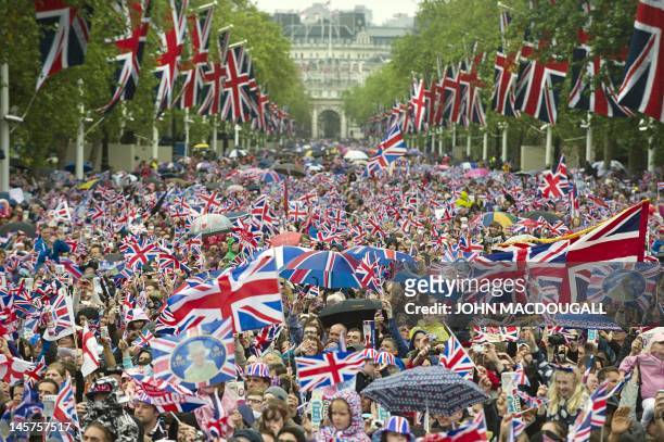 Huge crowds cheering with Britain's Union flags crowd the Mall towards Buckingham Palace to celebrate the Queen's Diamond Jubilee in London on June...