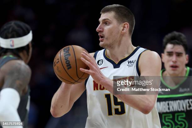 Nikola Jokic of the Denver Nuggets passes the ball against the Minnesota Timberwolves in the fourth quarter at Ball Arena on January 18, 2023 in...