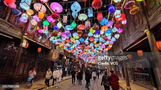 Tourists walk on the street decorated with colorful lanterns ahead of the Spring Festival on January 16, 2023 in Fuzhou, Jiangxi Province of China.