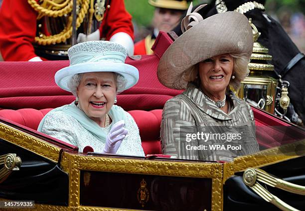 Queen Elizabeth and Camilla, Duchess of Cornwall pass the mall after Diamond Jubilee service of thanksgiving at St.Paul's Cathedral during the...