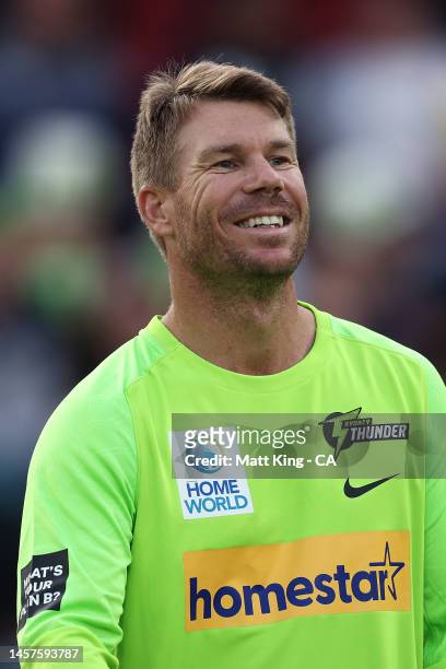 David Warner of the Thunder warms up prior to the Men's Big Bash League match between the Sydney Thunder and the Melbourne Renegades at Manuka Oval,...