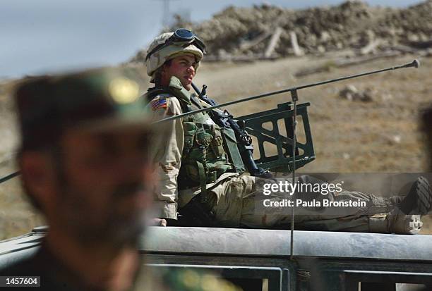 Army Military Police soldier from Massachussetts guards the graduation ceremony for the 3rd Battalion of the Afghan National Army October 3, 2002 in...