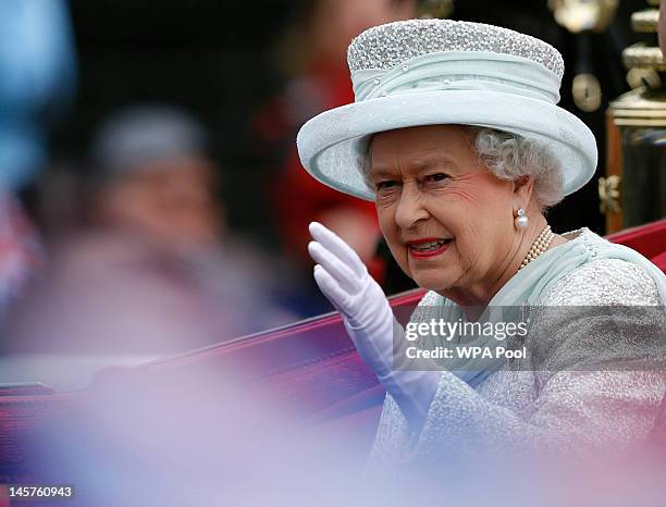 Queen Elizabeth II waves to spectators as she leaves Westminster Hall during the Diamond Jubilee celebrations on June 5, 2012 in London, England. For...