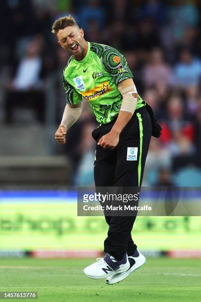 Daniel Sams of the Thunder celebrates taking the wicket of Martin Guptill of the Renegades during the Men's Big Bash League match between the Sydney...