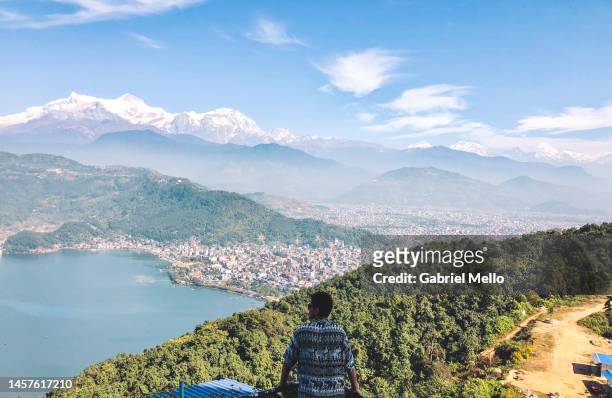 man at the top of the hill staring the views over pokhara - nepal pokhara stock pictures, royalty-free photos & images