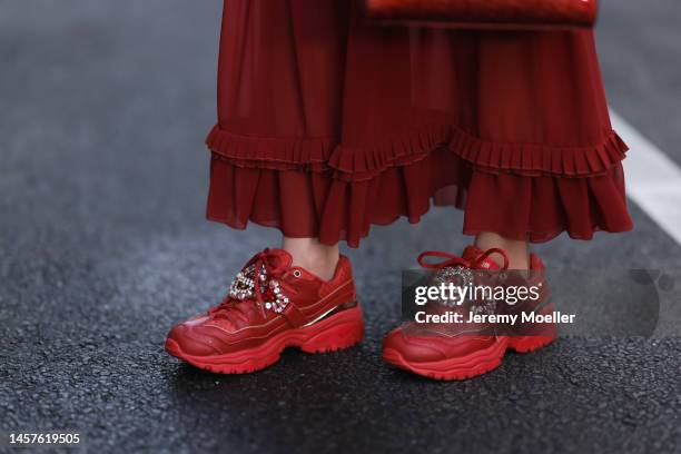 Palina Kozyrava seen wearing Maison Margiela Bordeaux long dress, Lady Dior small bag, Natkina silver jewelry, Skechers matching sneaker and Maurice...