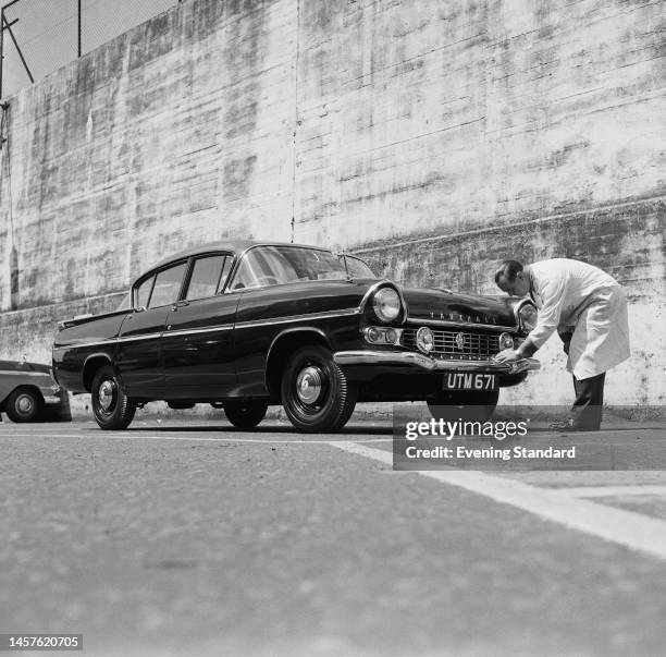 Man polishing the bumper of a Vauxhall Cresta car on July 20th, 1960.