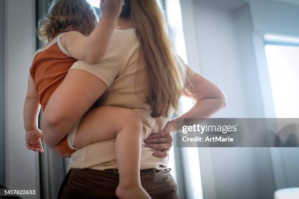 young mother suffering from backache - carrying stock pictures, royalty-free photos & images