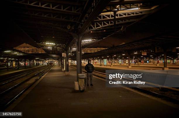 Traveller waits in vain at an empty Gare de l'Est Railway Station in Paris as France is hit by widespread traffic disruption as transport workers...