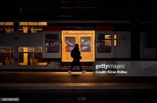 Passenger walks past an empty suburban train at Gare de l'Est Railway Station in Paris as France is hit by widespread traffic disruption as transport...