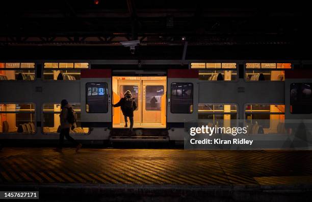 Passenger boards a suburban train at Gare de l'Est Railway Station in Paris as France is hit by widespread traffic disruption with limited services...