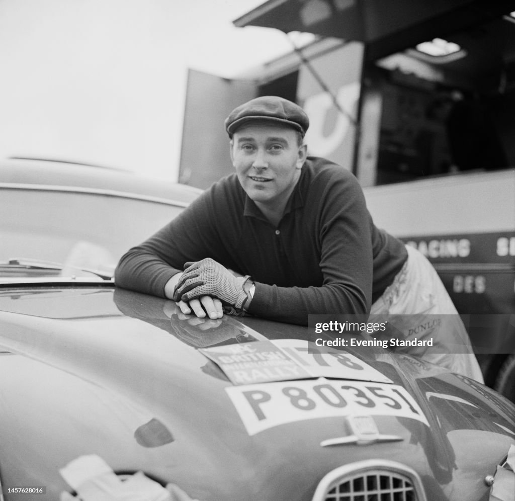 Swedish rally driver Erik Carlsson posing with his Saab 96 car during ...