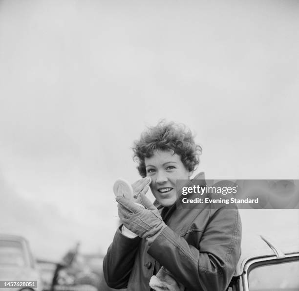 British rally driver Pat Moss powdering her face during the RAC International Rally of Great Britain, from November 21st - 26th, 1960.