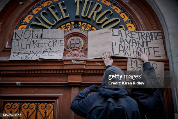 High School students put up placards that reads "Retirement before Arthritis" at the entrance to Lycee Turgot as part of a nationwide strike against...