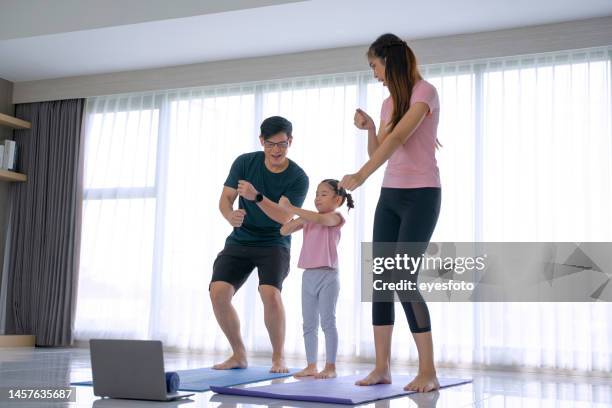 family with one daughter are exercising at home. - chinese dance stock pictures, royalty-free photos & images