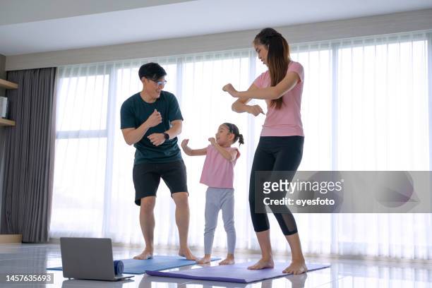 family with one daughter are exercising at home. - chinese dance stock pictures, royalty-free photos & images