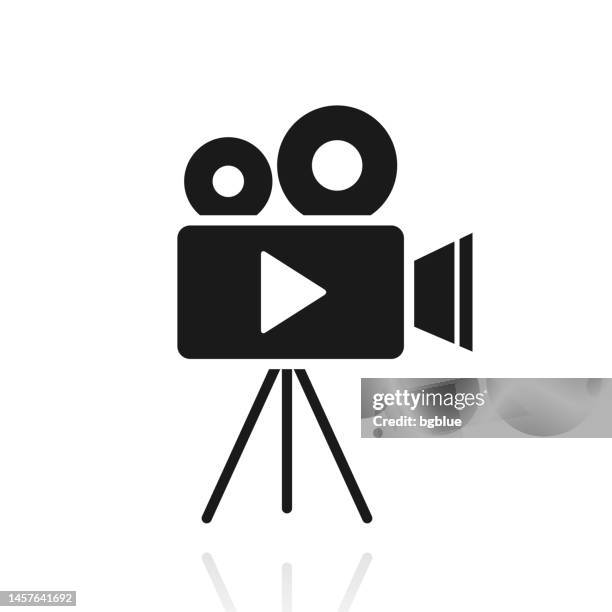 video camera with tripod. icon with reflection on white background - vintage television white background stock illustrations