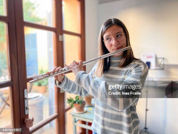 young teenage girl playing the transverse flute - flauta imagens e fotografias de stock