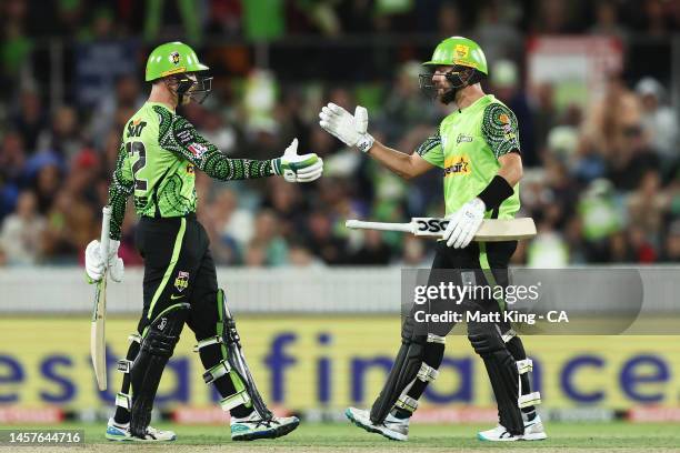 Matthew Gilkes and Alex Ross of the Thunder celebrate victory during the Men's Big Bash League match between the Sydney Thunder and the Melbourne...