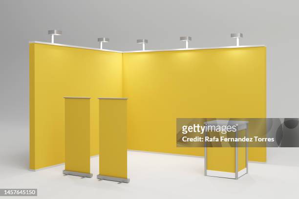 standard exhibition stand with spotlights with yellow blank panels, advertising stand. 3d render - stand 3d stock pictures, royalty-free photos & images