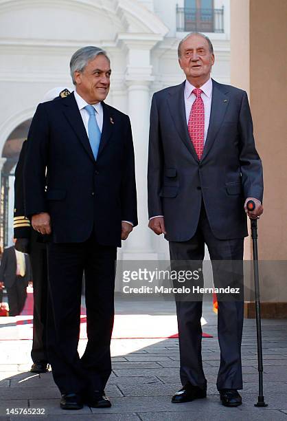 King Juan Carlos of Spain and the President of Chile Sebastián Piñera walk during the visit to the Presidential Palace on June 5, 2012 in Santiago,...